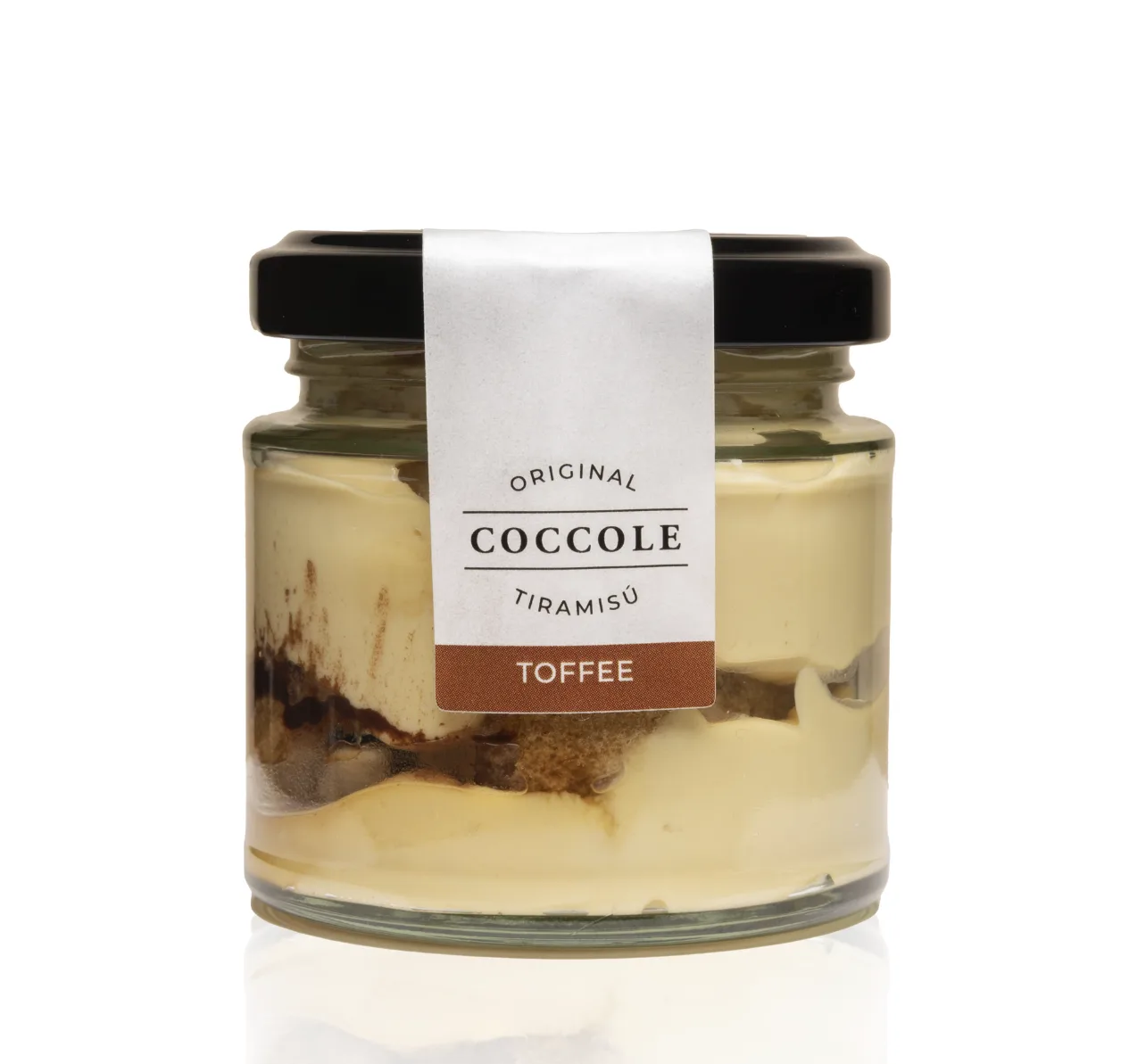 A glass jar of Coccole toffee tiramisù with a brown Toffee label, showing cream, sponge and a dark toffee layer