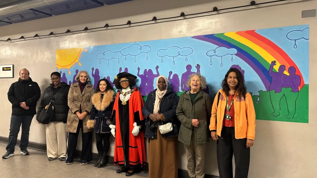 The Mayor of Islington, artist Lydia Rose and residents in front of the new mural inside Finsbury Park Tube station